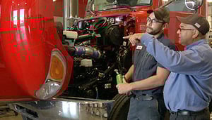 two big rig mechanics at truck
